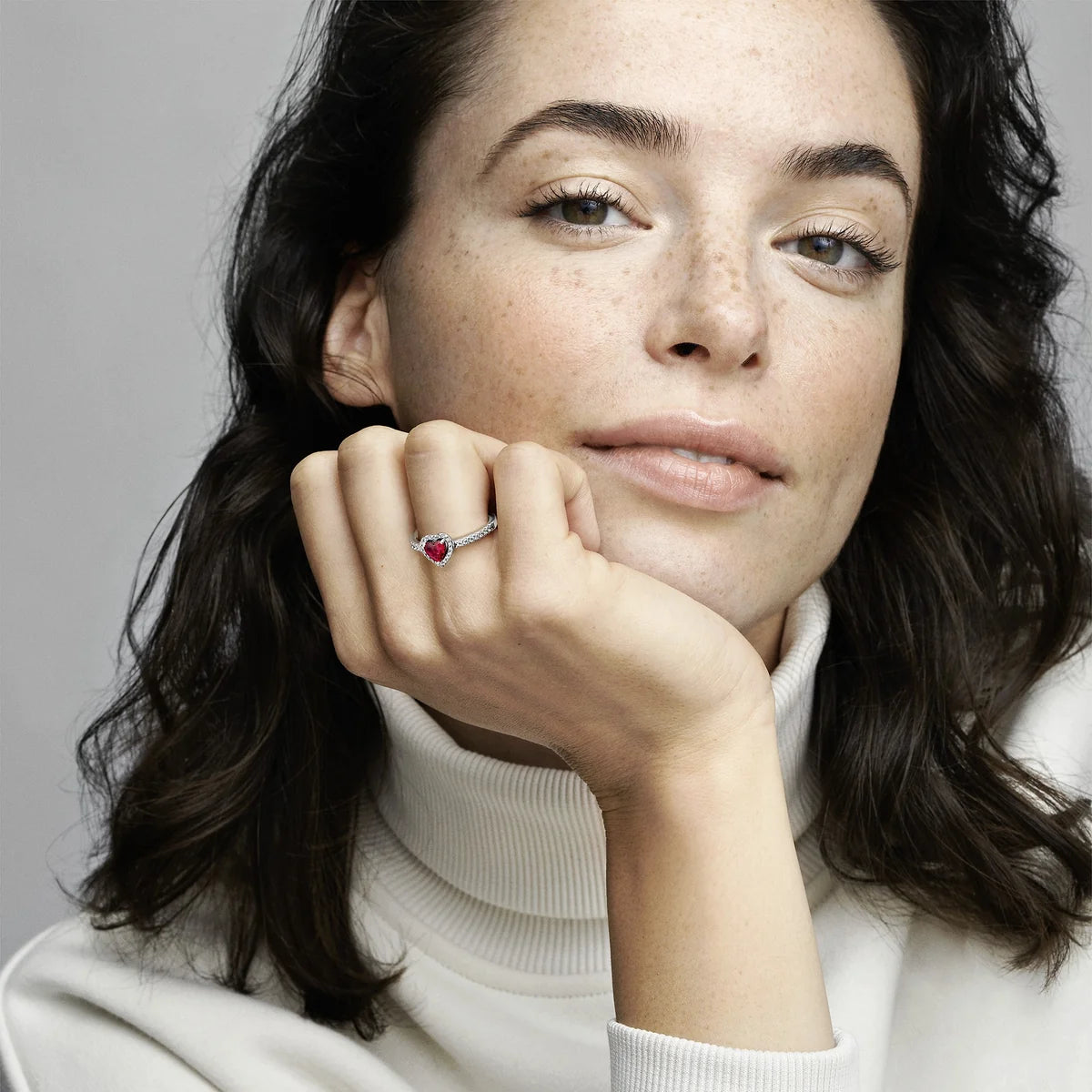 Model wearing Pandora red heart ring on finger