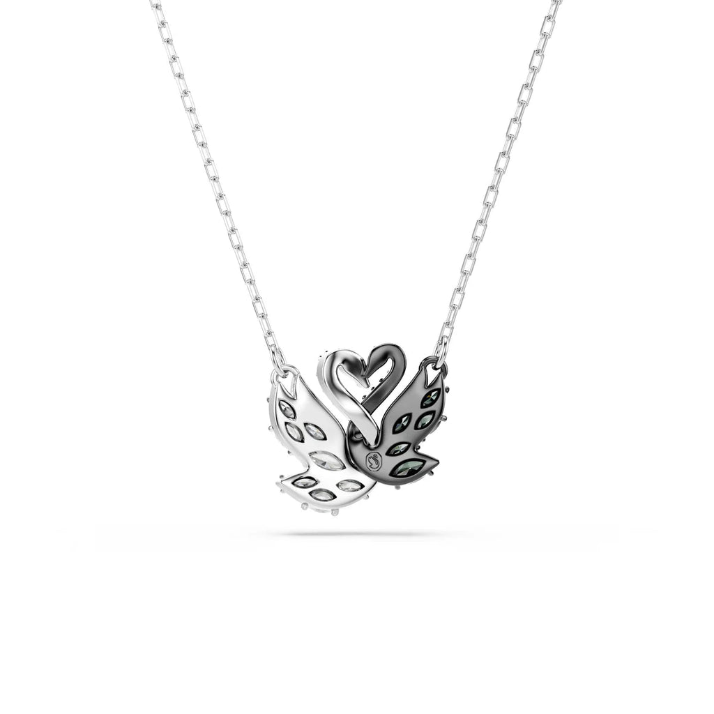 Double swan pendant close-up showing black and white swans with zirconia stones forming a heart shape